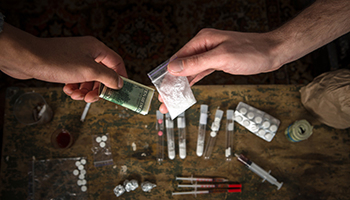 A close-up view of drugs and money on a table